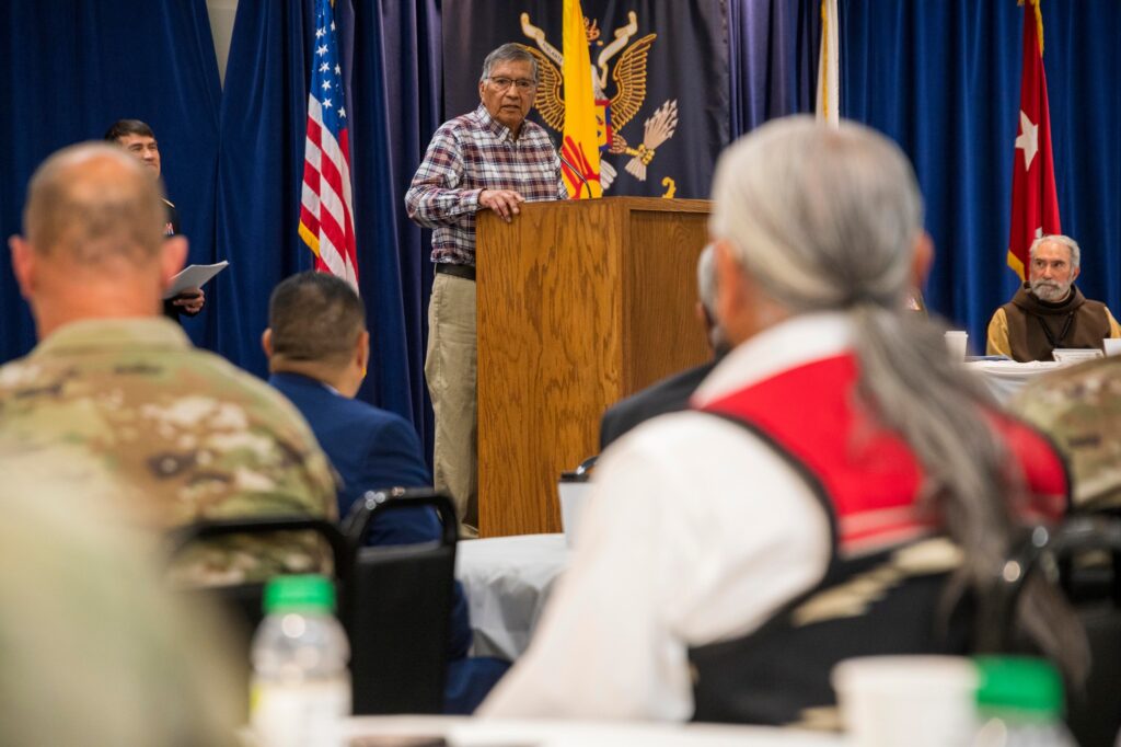 Luis Naranjo speaks to the audience before delivering a Native American prayer.