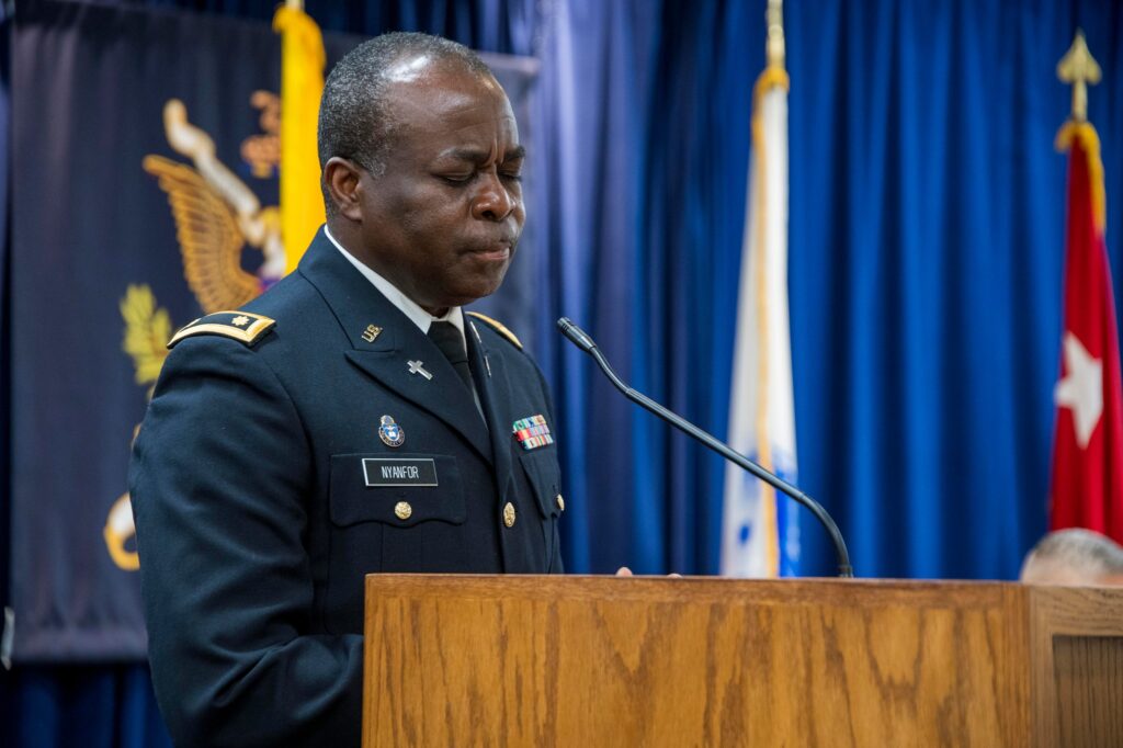 Chaplain (Maj.) Arthur Nyanfor prays for a blessing of the food.